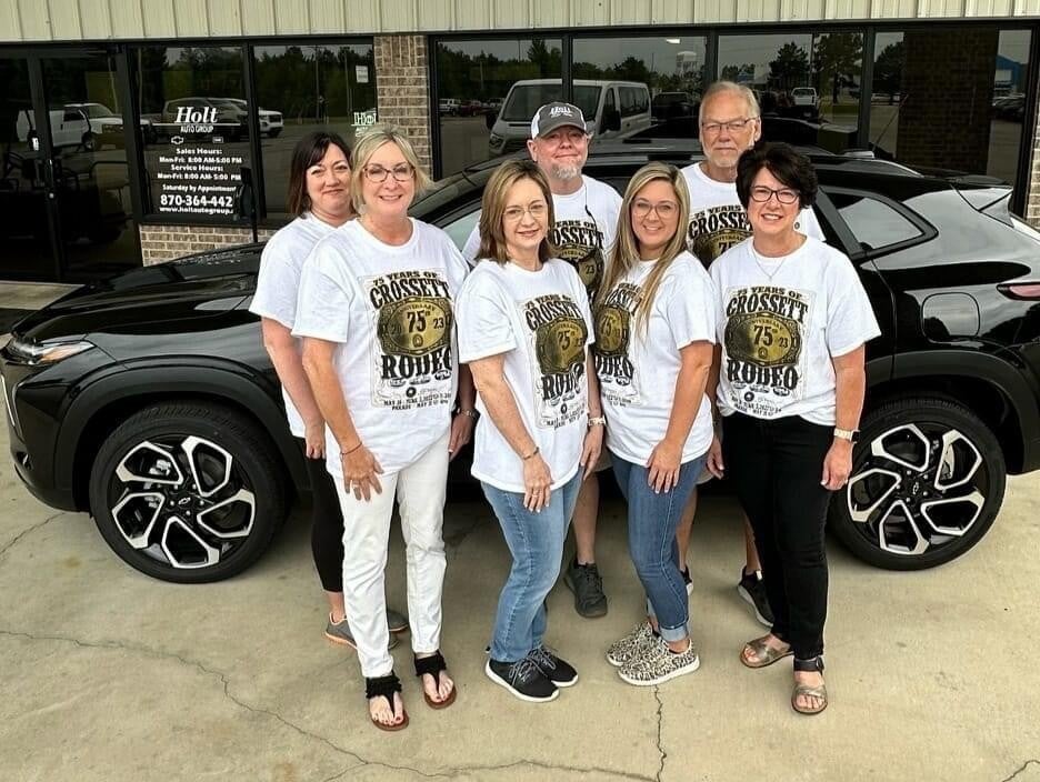 six group members photo near black car