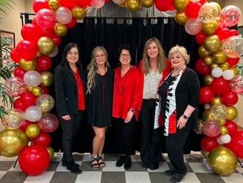 five members group photo near celebration zone