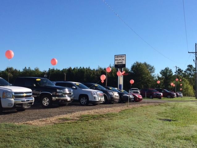 many cars tied with balloons